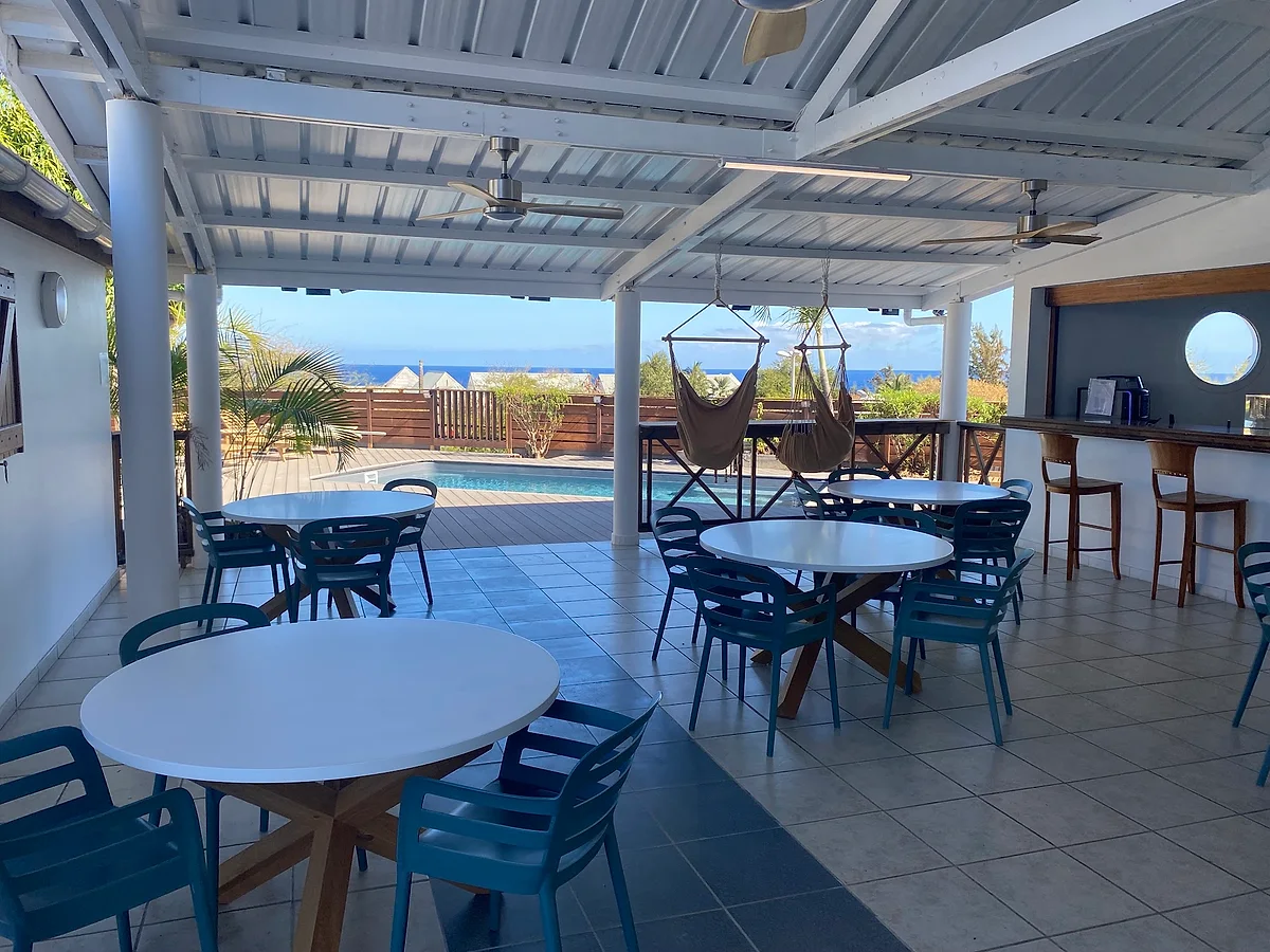 La salle du petit-déjeuner, ouverte sur la piscine et l'océan